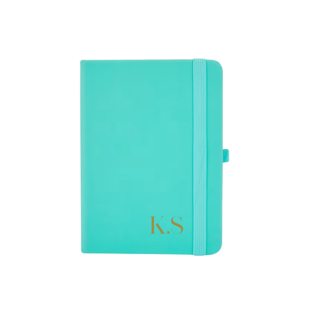 Teal A6 vegan leather notebook with personalised initials K.S printed on the bottom right corner.