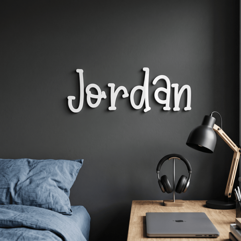 Wall decor with the name 'Jordan' above a desk with a laptop and lamp.