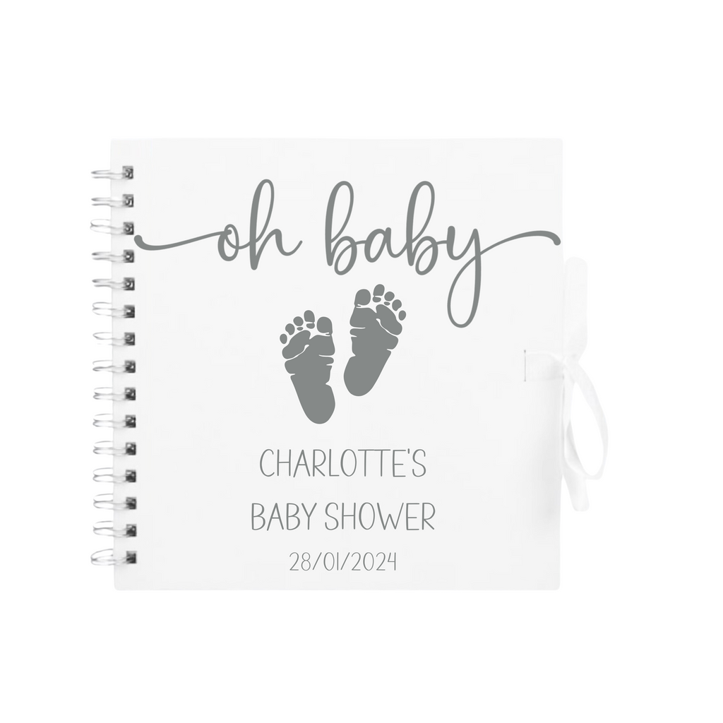 White scrapbook with silver "oh baby" text and grey baby footprints – customised baby shower photo album gift with Charlotte’s details.