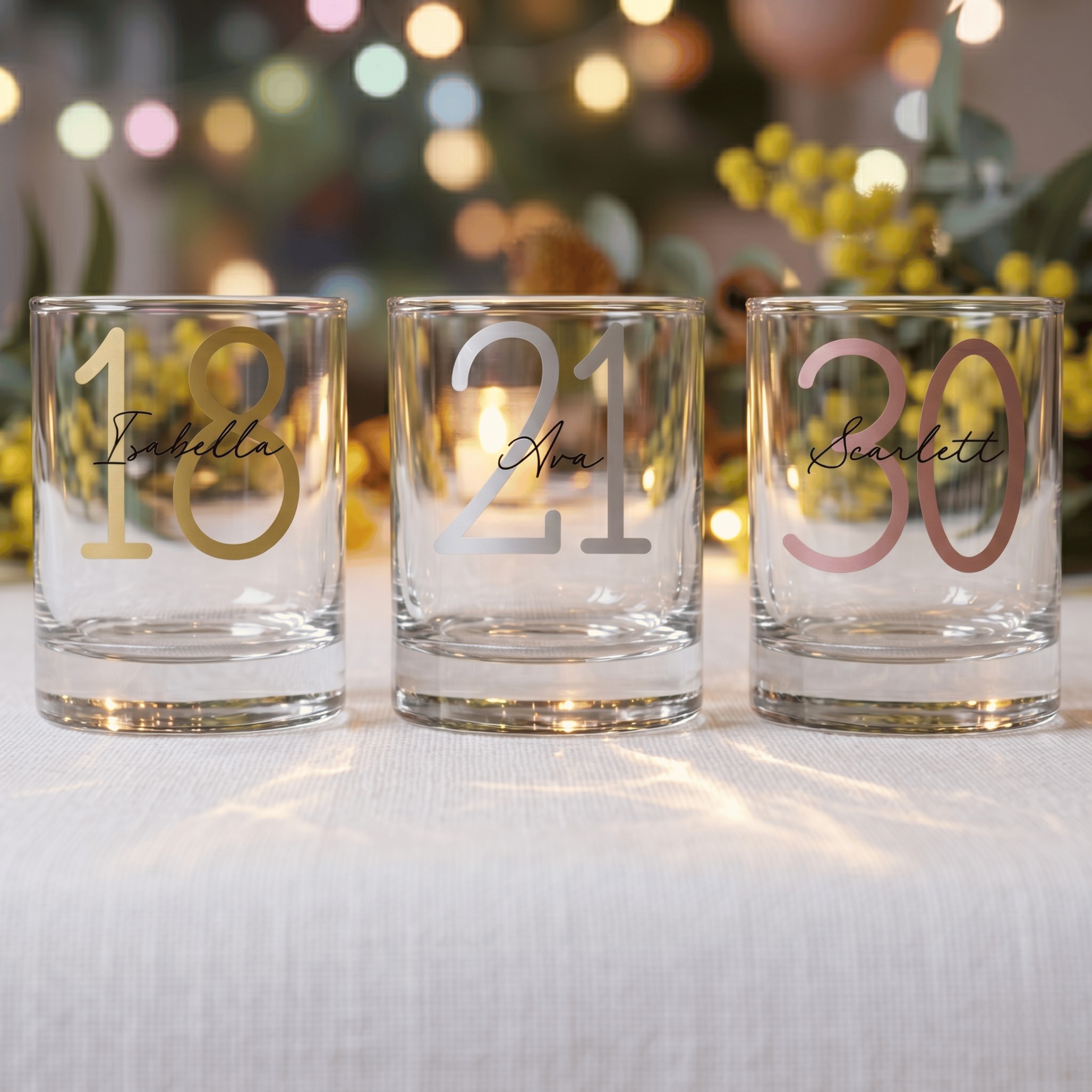 Three personalized glasses with numbers and names on a festive background