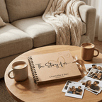 Personalised photo album titled 'The Story of Us' with coffee cups and photos on a wooden table.