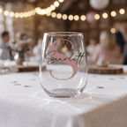 Clear glass with 'Scarlett' monogram on a tablecloth with blurred background