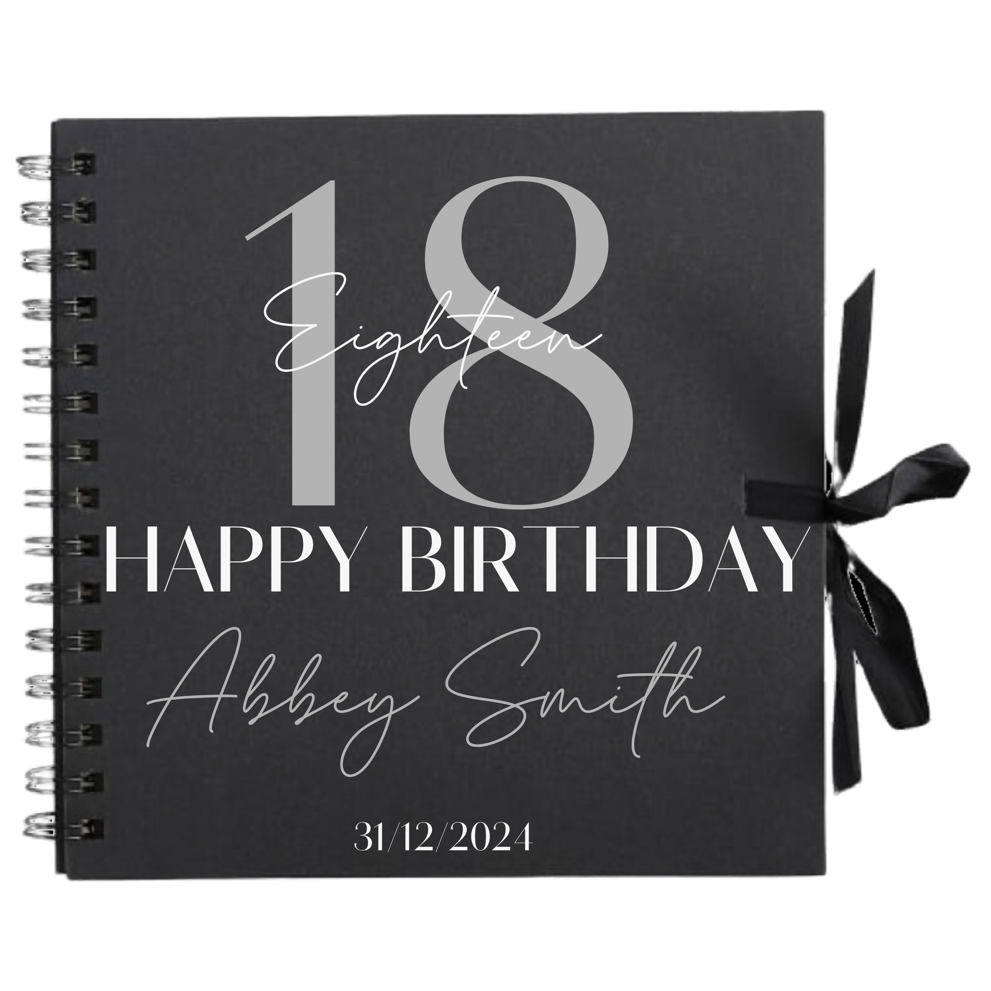 Close-up of 18th birthday personalised scrapbook album in black with ribbon tie, name and date on cover