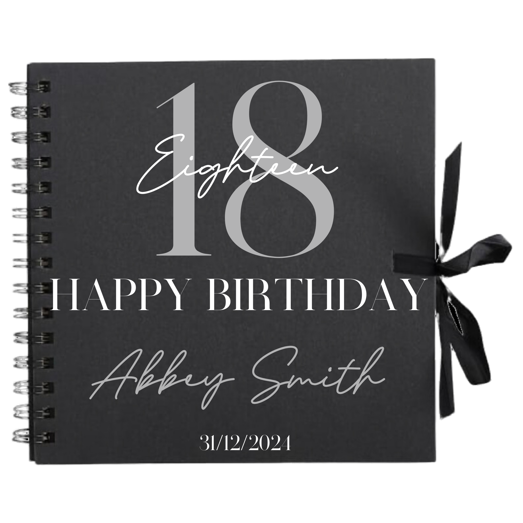 Close-up of 18th birthday personalised scrapbook album in black with ribbon tie, name and date on cover