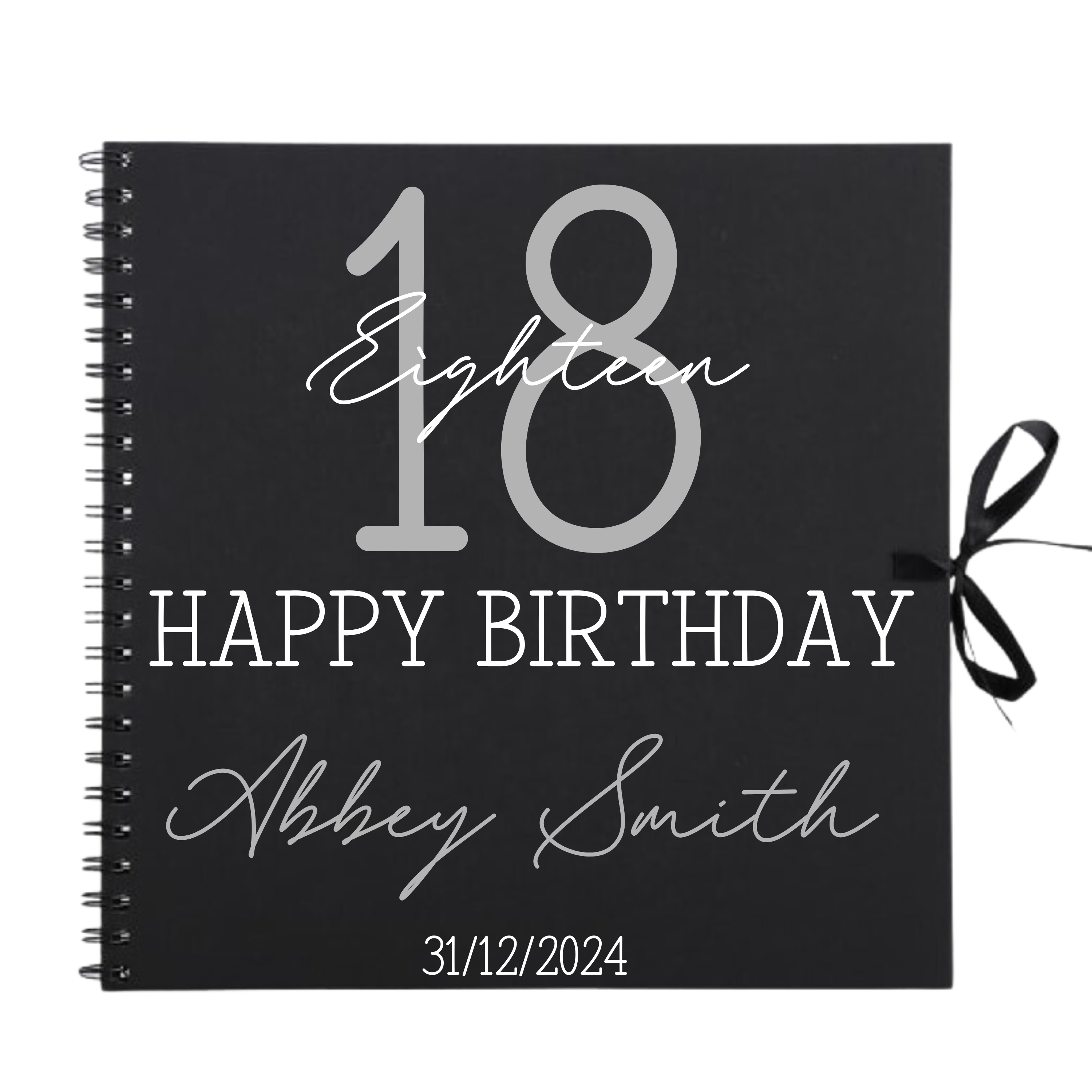 Close-up of 18th birthday personalised scrapbook album in black with ribbon tie, name and date on cover