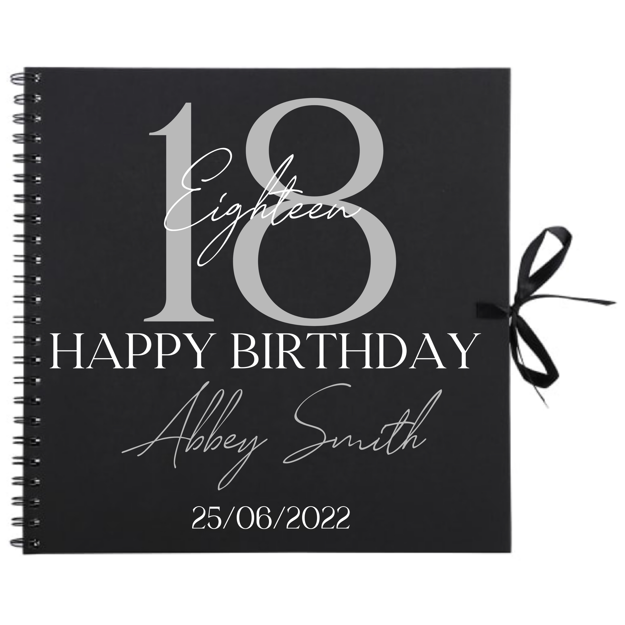 Close-up of 18th birthday personalised scrapbook album in black with ribbon tie, name and date on cover