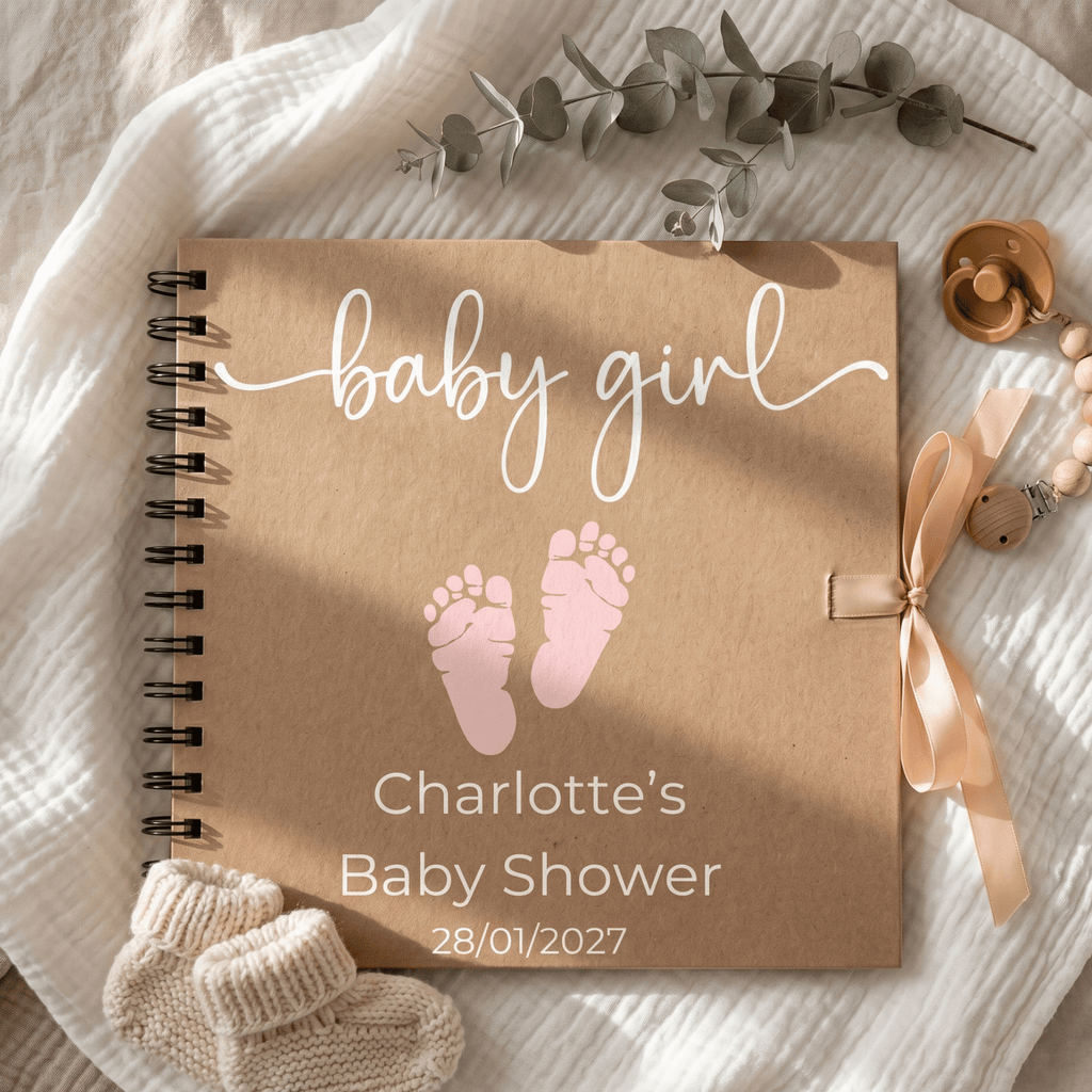 Baby girl themed Album with pink footprints, ribbon, and baby shower details on a soft fabric background.