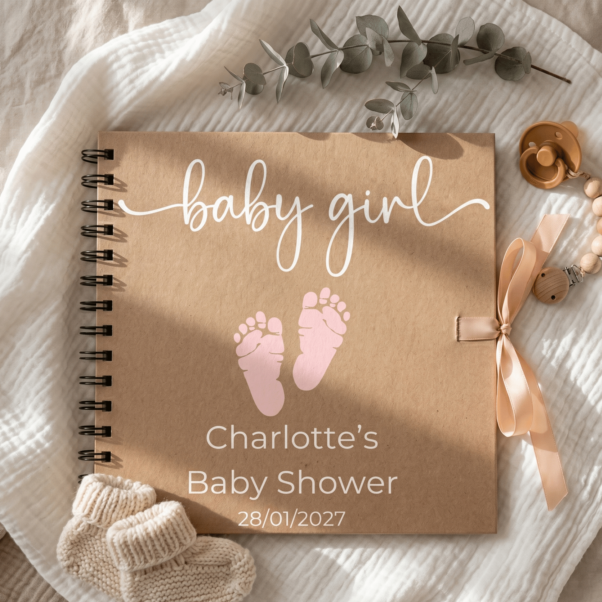 Baby girl themed Album with pink footprints, ribbon, and baby shower details on a soft fabric background.