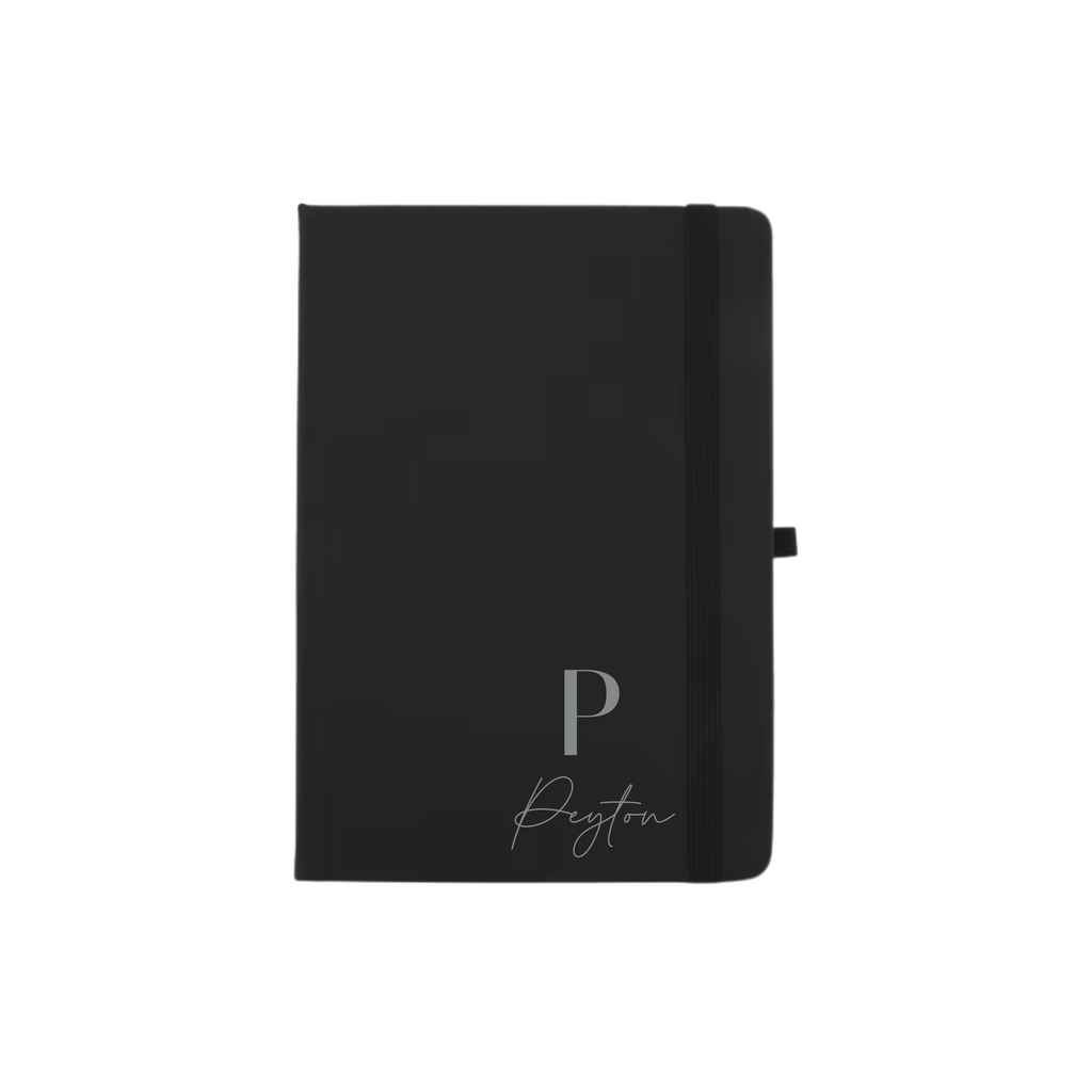 Black A5 vegan leather hard cover notebook personalised with initial P and name Peyton in silver.
