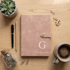 Pink notebook with 'Grace' on a wooden desk with office supplies