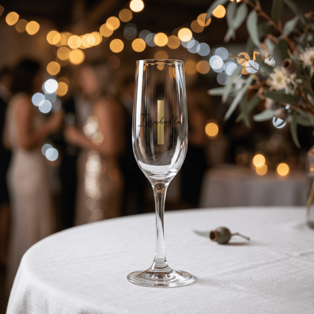 Clear glass with branding on a tablecloth, blurred festive background