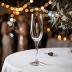 Clear glass with branding on a tablecloth, blurred festive background