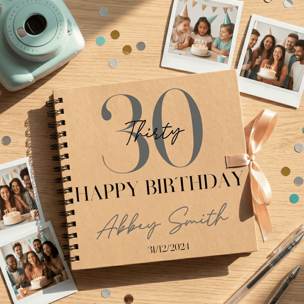 Personalised '30 Happy Birthday' Album with photos and a camera on a wooden surface.