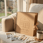 Brown photo album with house illustration and 'Charlotte & Ben Home Renovation' text on a couch with photos and a mug.
