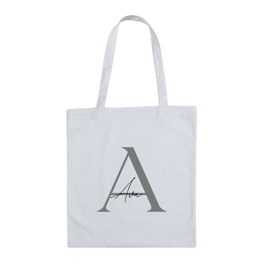 White personalised tote bag featuring silver letter A and custom name "Ava" – lightweight cotton initial gift bag.