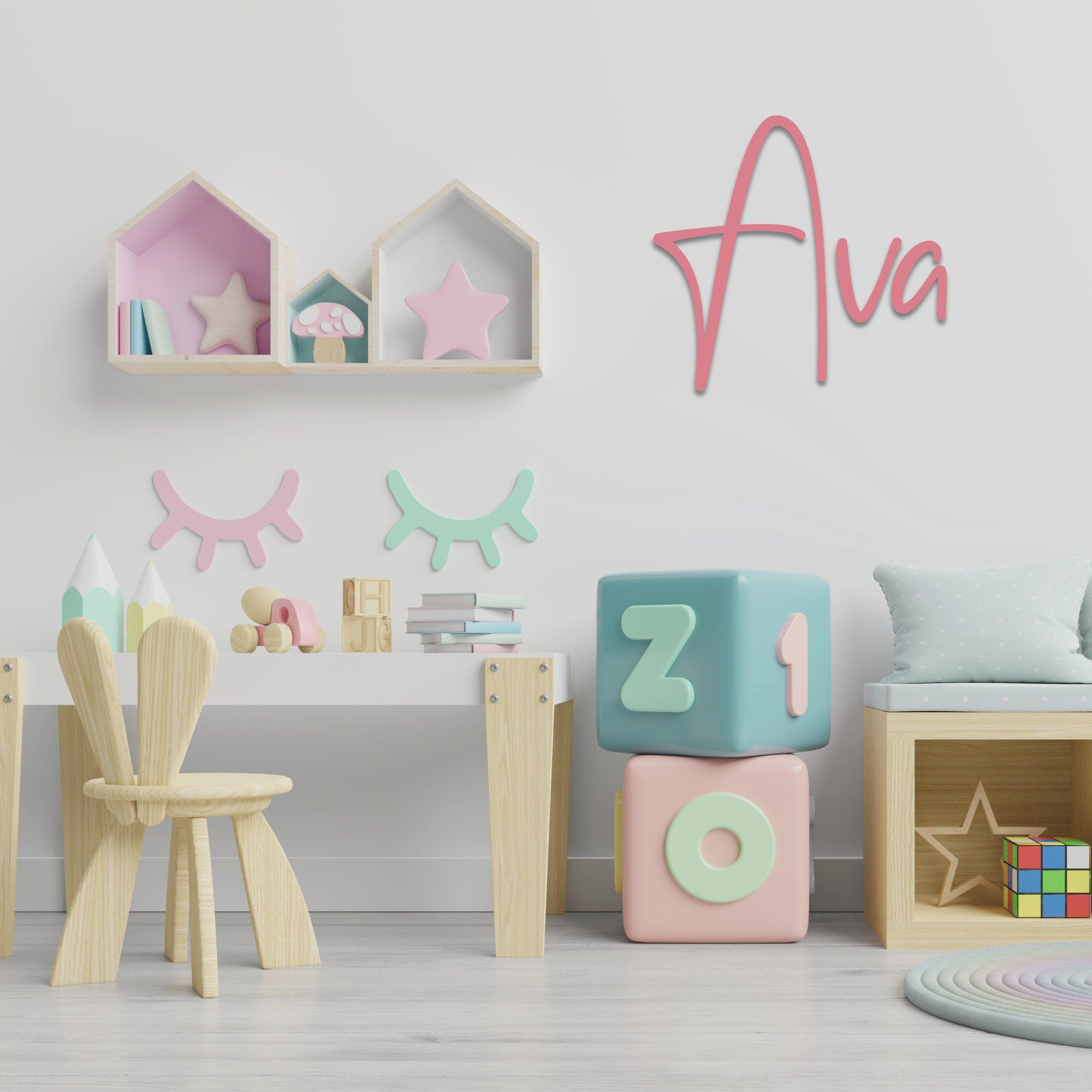 Pink acrylic custom name sign "Ava" on playroom wall with pastel blocks and shelf decor