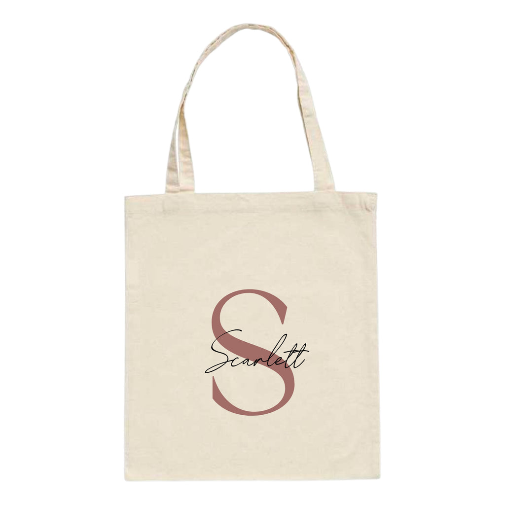Natural cotton tote bag with custom name "Scarlett" and large rose gold letter S printed on front – personalised initial tote bag gift.
