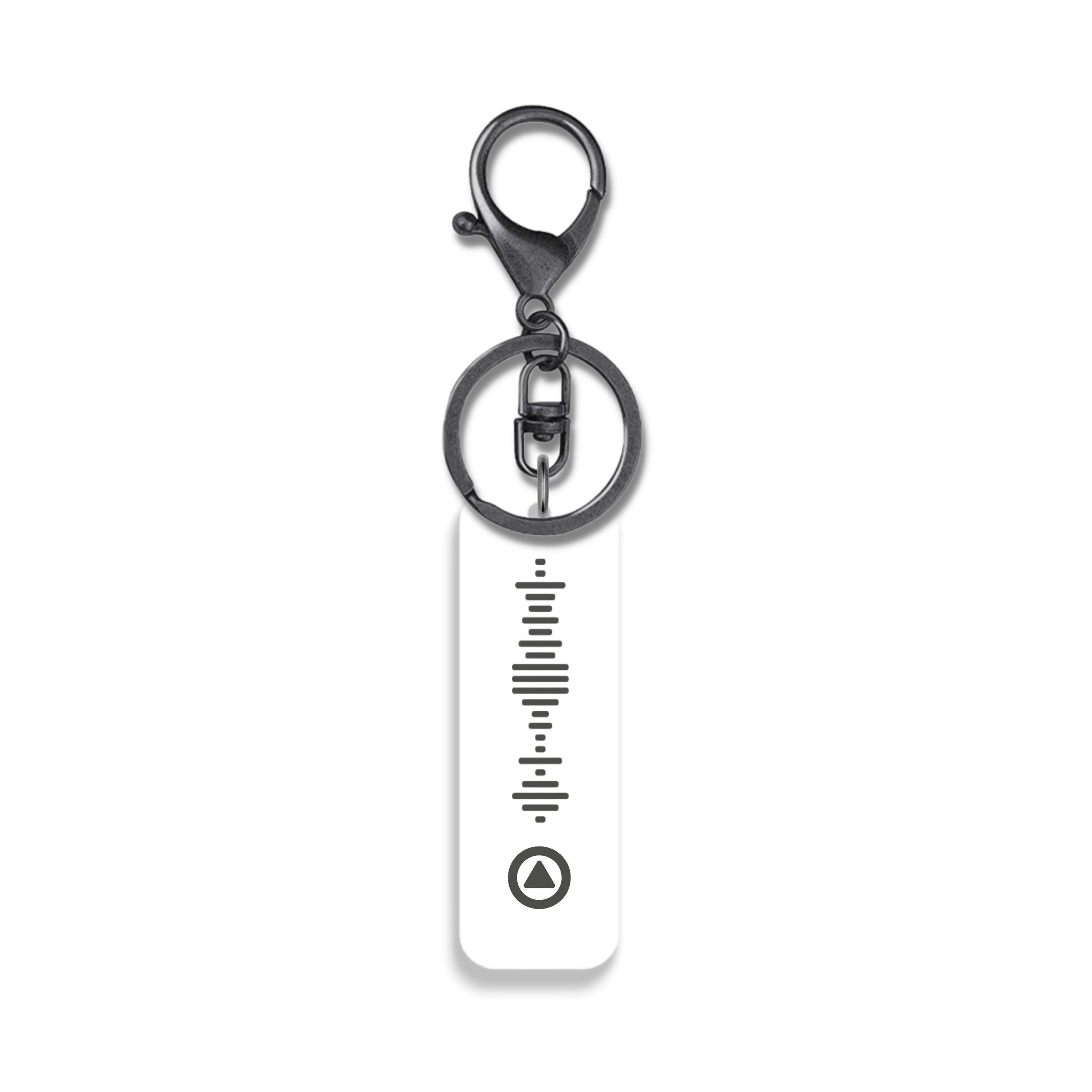 Custom music QR code keyring in white acrylic with black engraving and gunmetal hardware – personalised playlist gift.
