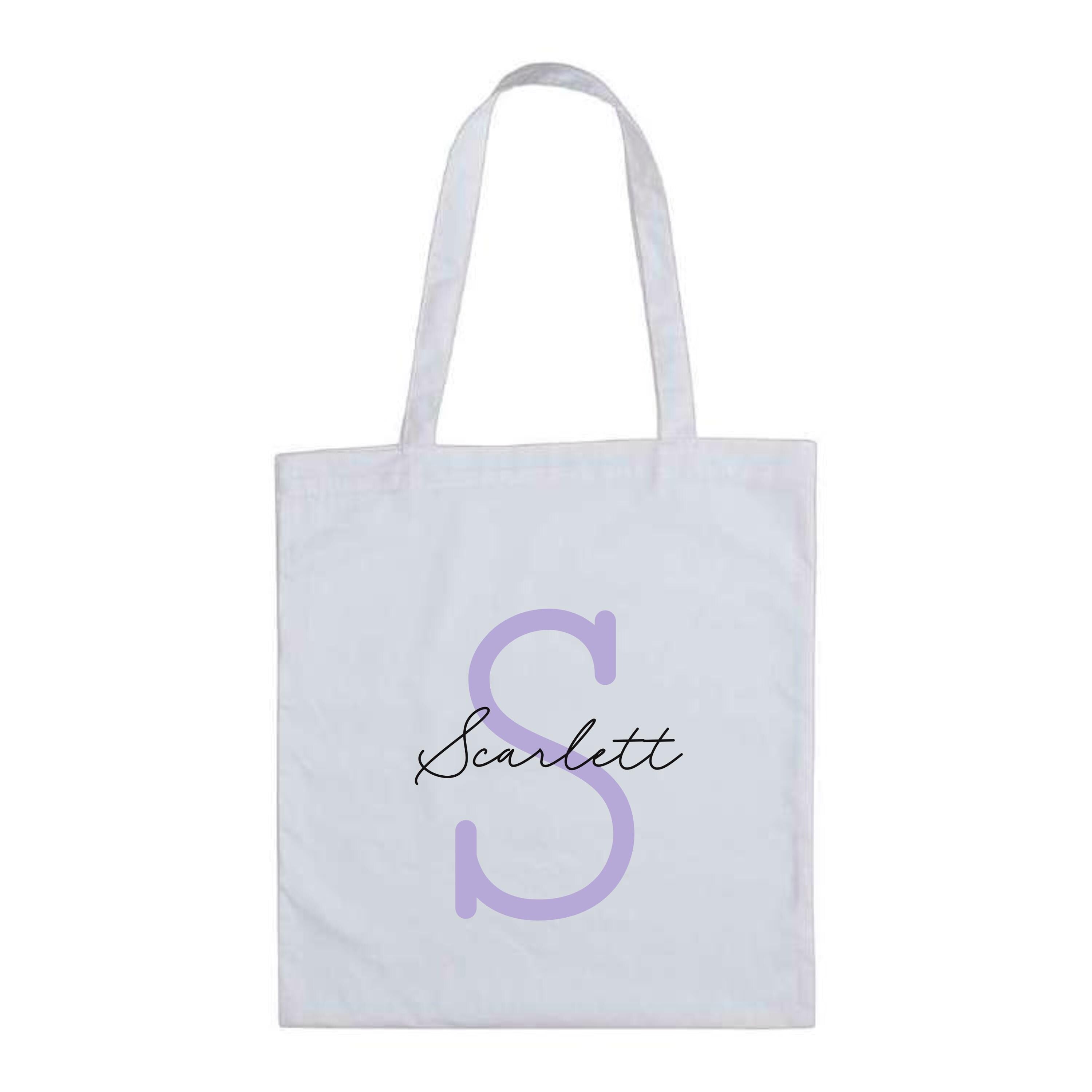 White cotton tote bag with lilac letter S and the name "Scarlett" – custom reusable personalised initial tote bag.