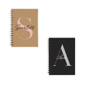 Set of two personalised A5 spiral notebooks – brown kraft with Ava and black with Scarlett, custom name and initial.