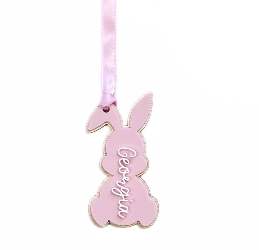 Pink acrylic bunny Easter basket tag with “Georgia” in white raised script – custom name tag with pink satin ribbon.