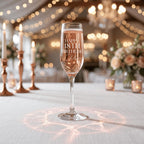 Champagne flute with personalised text on a decorated table with lights and flowers