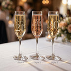 Three champagne flutes with personalised inscriptions on a tablecloth.