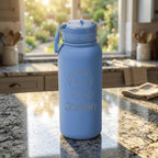 Blue water bottle with a cat illustration and 'Jordan' text on a kitchen counter.