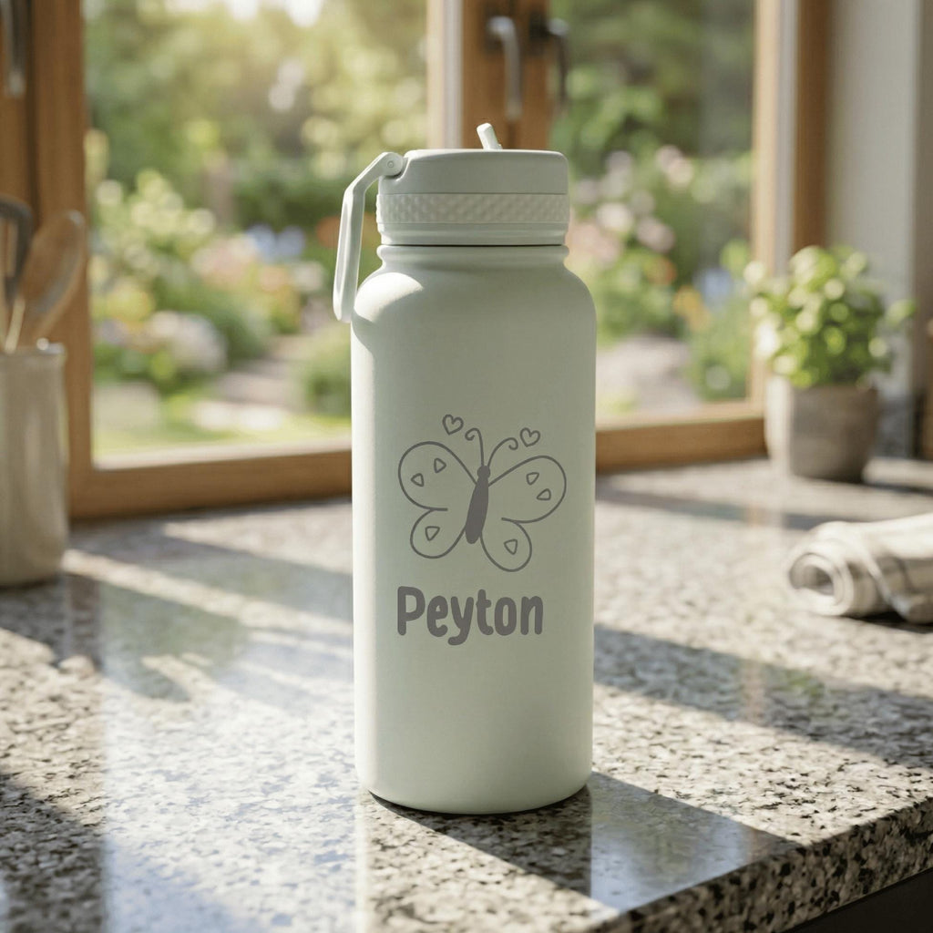 Light green water bottle with butterfly design and 'Peyton' text on a kitchen counter.