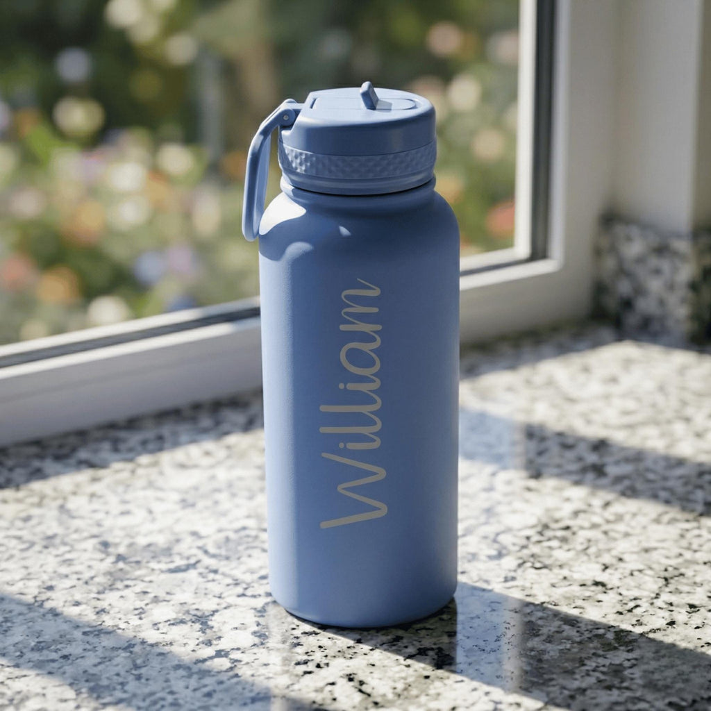 Blue water bottle with 'William' engraving on a windowsill