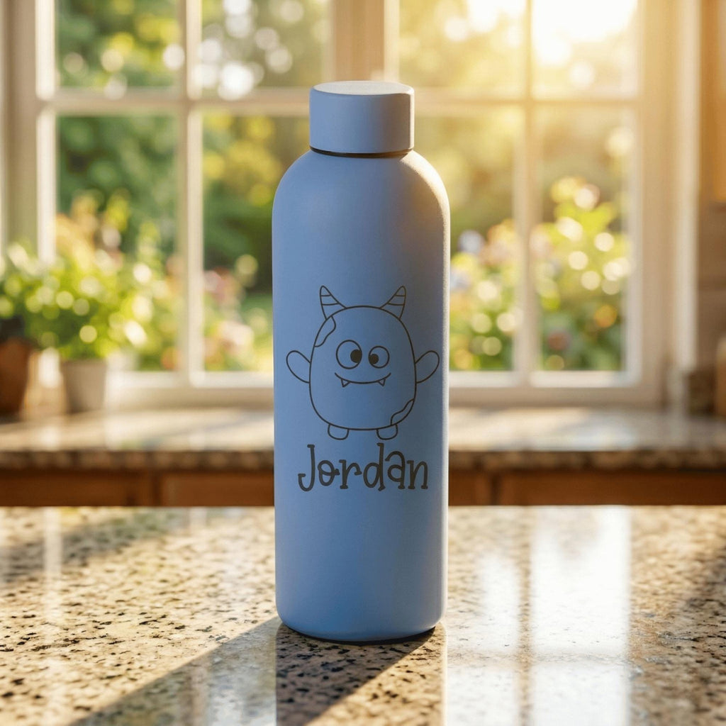 Blue water bottle with a cartoon character and 'Jordan' text on a table with a window in the background