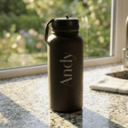 Black water bottle with 'Andy' engraving on a kitchen counter
