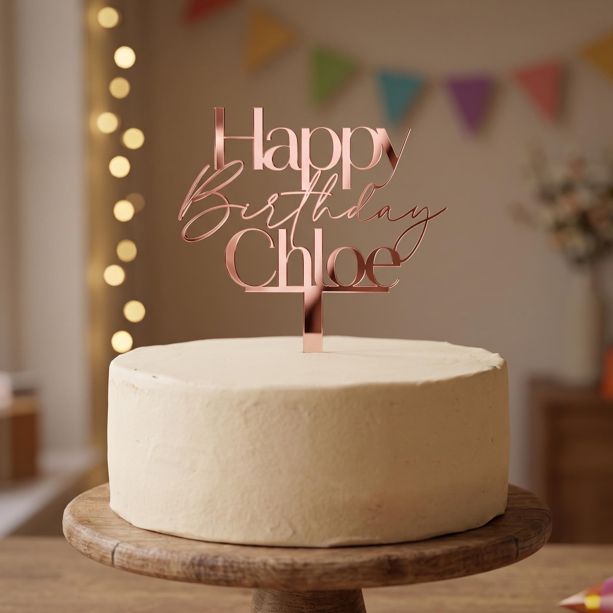 Personalised Happy Birthday Chloe rose gold mirror acrylic cake topper in modern sans and fluid script font.