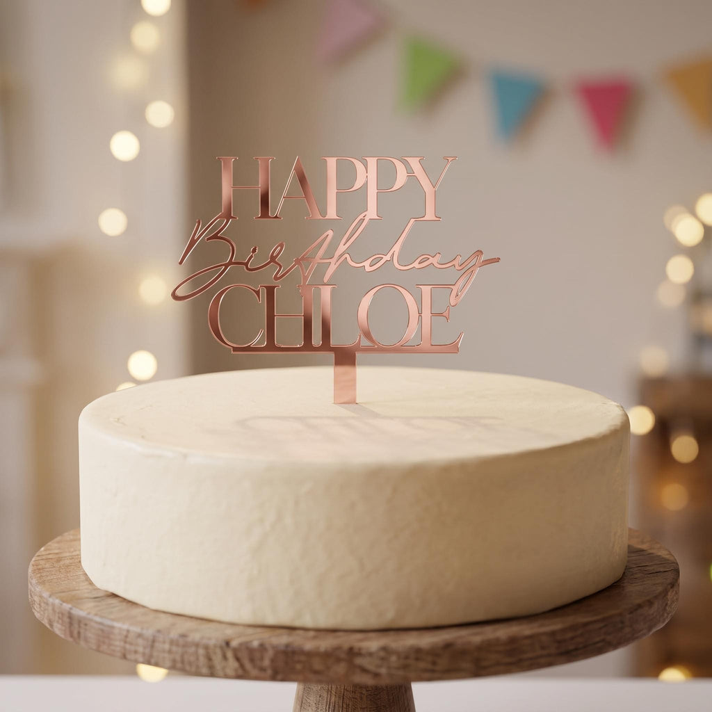 Personalised Happy Birthday Chloe rose gold mirror acrylic cake topper in all caps serif and script font.