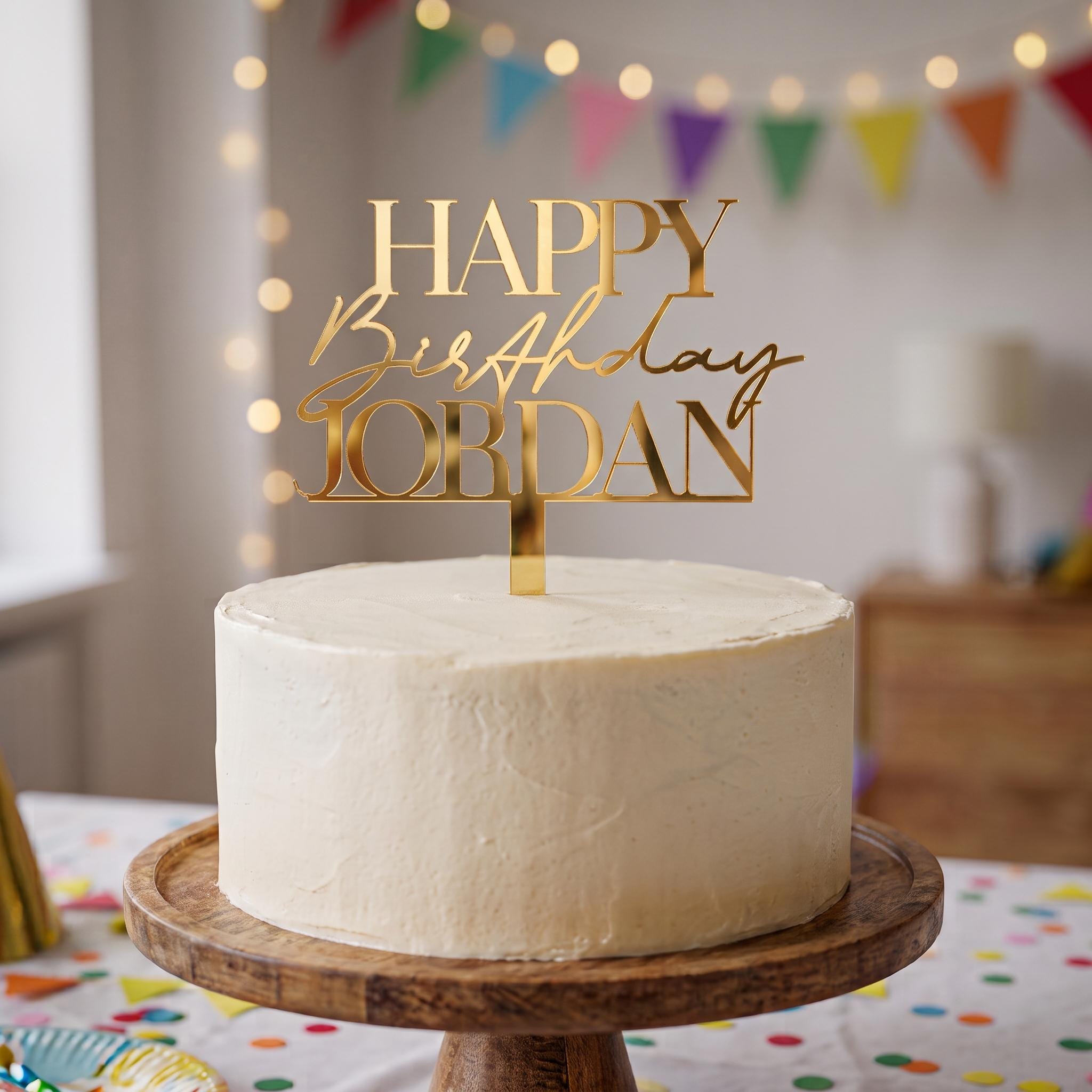 Bespoke Happy Birthday Jordan gold mirror acrylic cake topper with bold all caps serif name lettering.