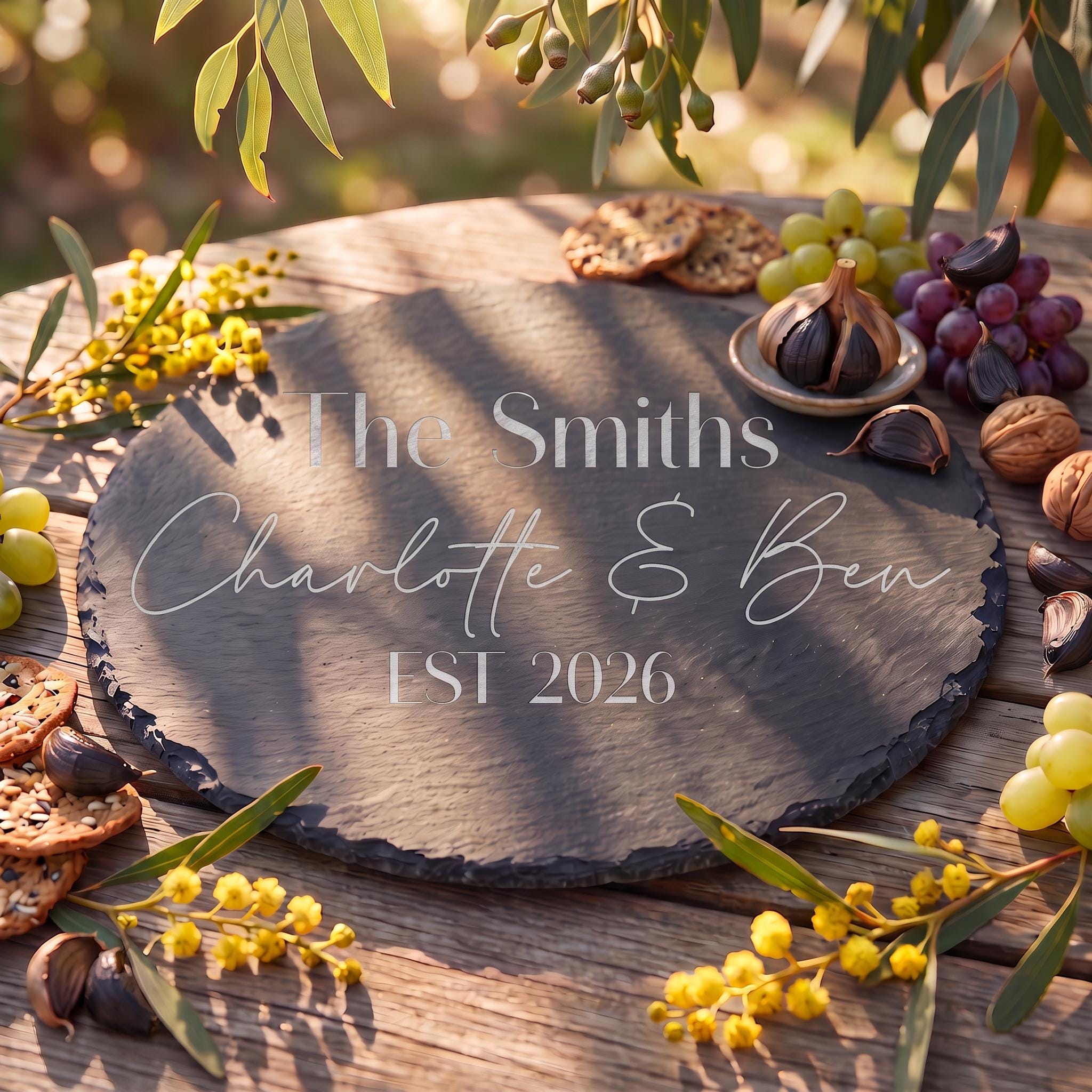 Bespoke engraved round slate board showing The Smiths Charlotte and Ben EST 2026 on natural dark stone.