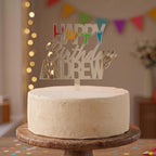Custom Happy Birthday Andrew silver mirror acrylic cake topper positioned on a celebration cake.