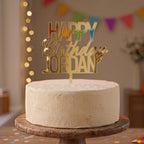 Bespoke Happy Birthday Jordan gold mirror acrylic cake topper with bold block name lettering.