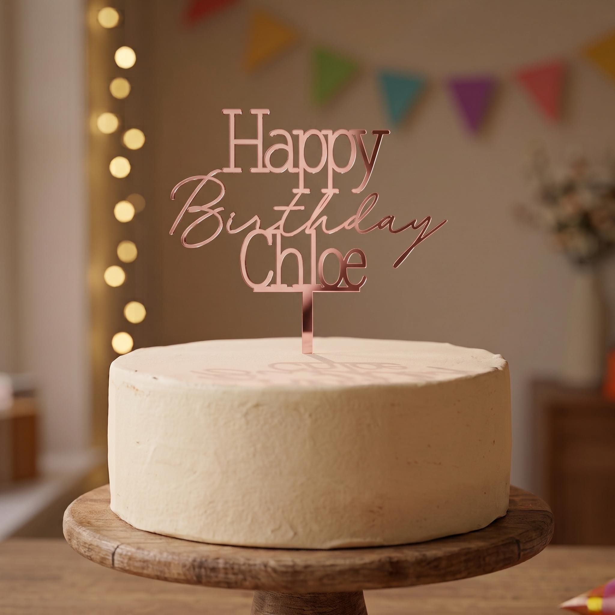 Personalised Happy Birthday Chloe rose gold mirror acrylic cake topper in classic serif and script font.
