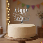 Custom Happy Birthday Andrew silver mirror acrylic cake topper placed on an iced cake.