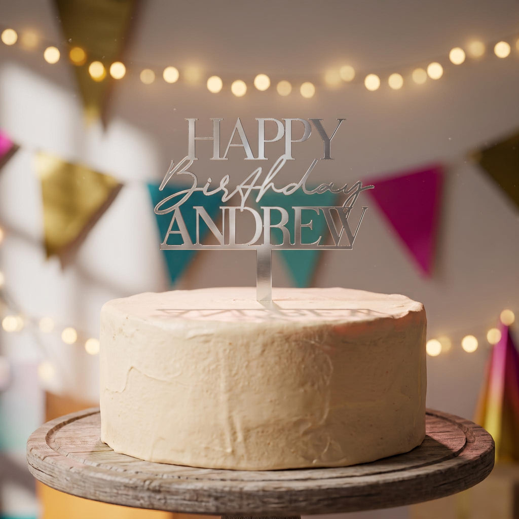 Custom Happy Birthday Andrew silver mirror acrylic cake topper positioned on a celebration cake.