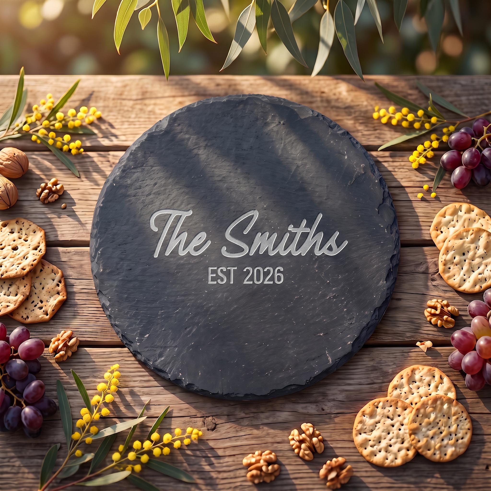 Custom circular slate serving platter engraved with The Smiths EST 2026 on timber background with wattle blossoms.
