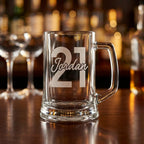 Personalised glass beer mug engraved with a custom name and milestone number, custom beer stein for birthdays and groomsmen gifts
