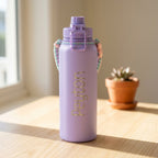 Rear perspective of the lilac personalised water bottle with woven handle clipped behind the leak proof sports spout.