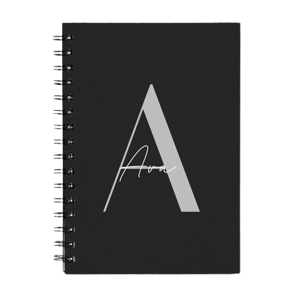 Personalised A5 spiral notebook with custom initial and name in modern script and sans-serif fonts by Make It Personal Gift Co.