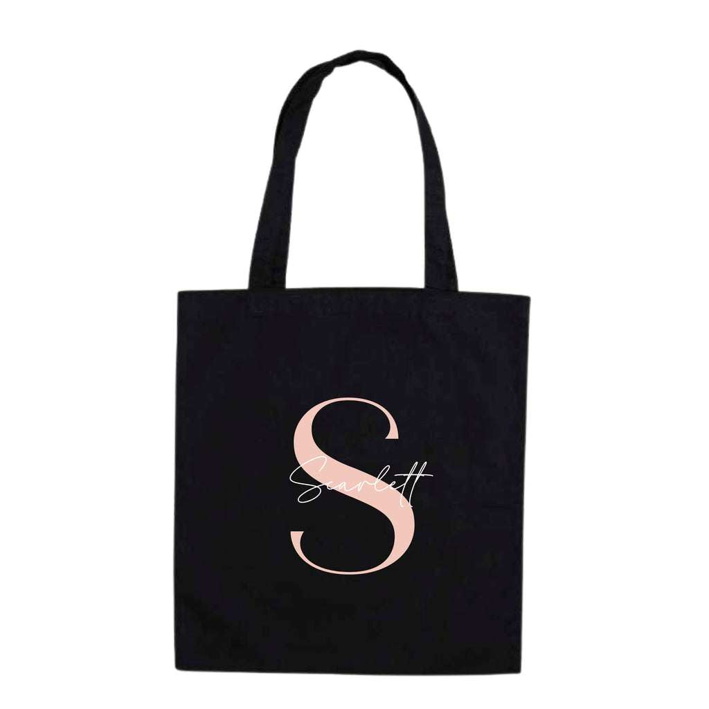 White personalised tote bag by Make It Personal Gift Co with modern script and sans-serif initials and name design.