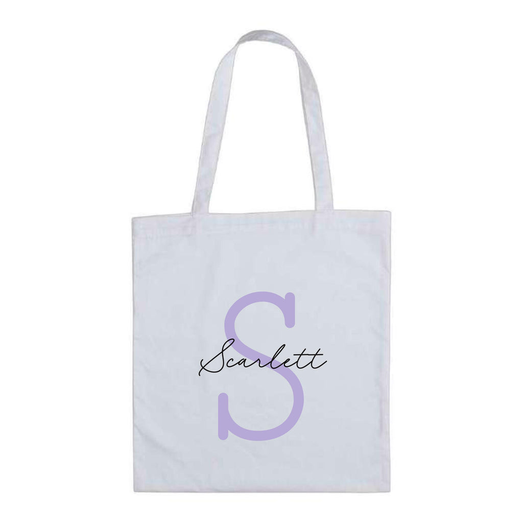 White personalised tote bag by Make It Personal Gift Co with monoline script and slab serif initials and name design.