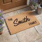 High angle view of a natural coconut fibre personalised entry mat displaying custom family text.