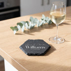 Personalised engraved geometric slate coaster styled with a glass mug on a timber coffee table in Australia.