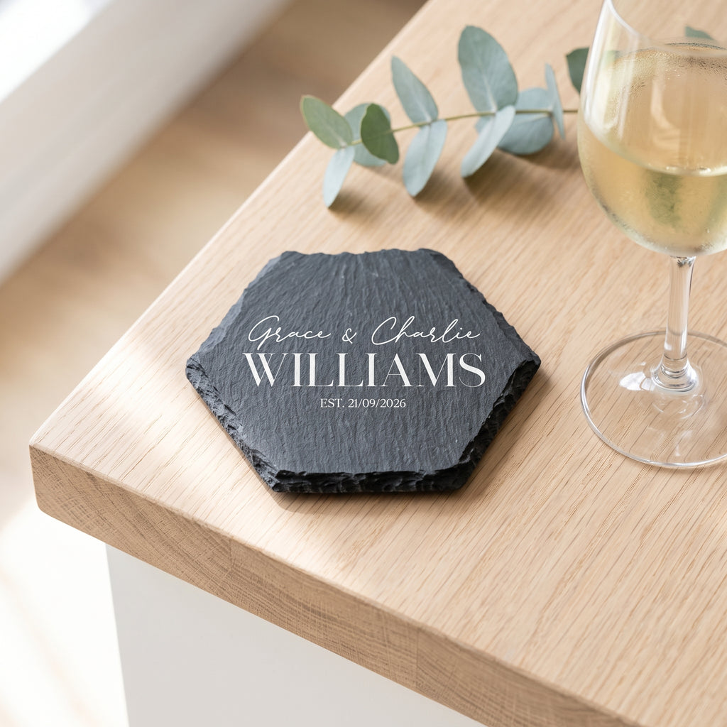Personalised engraved geometric slate coaster styled with a glass mug on a timber coffee table in Australia.